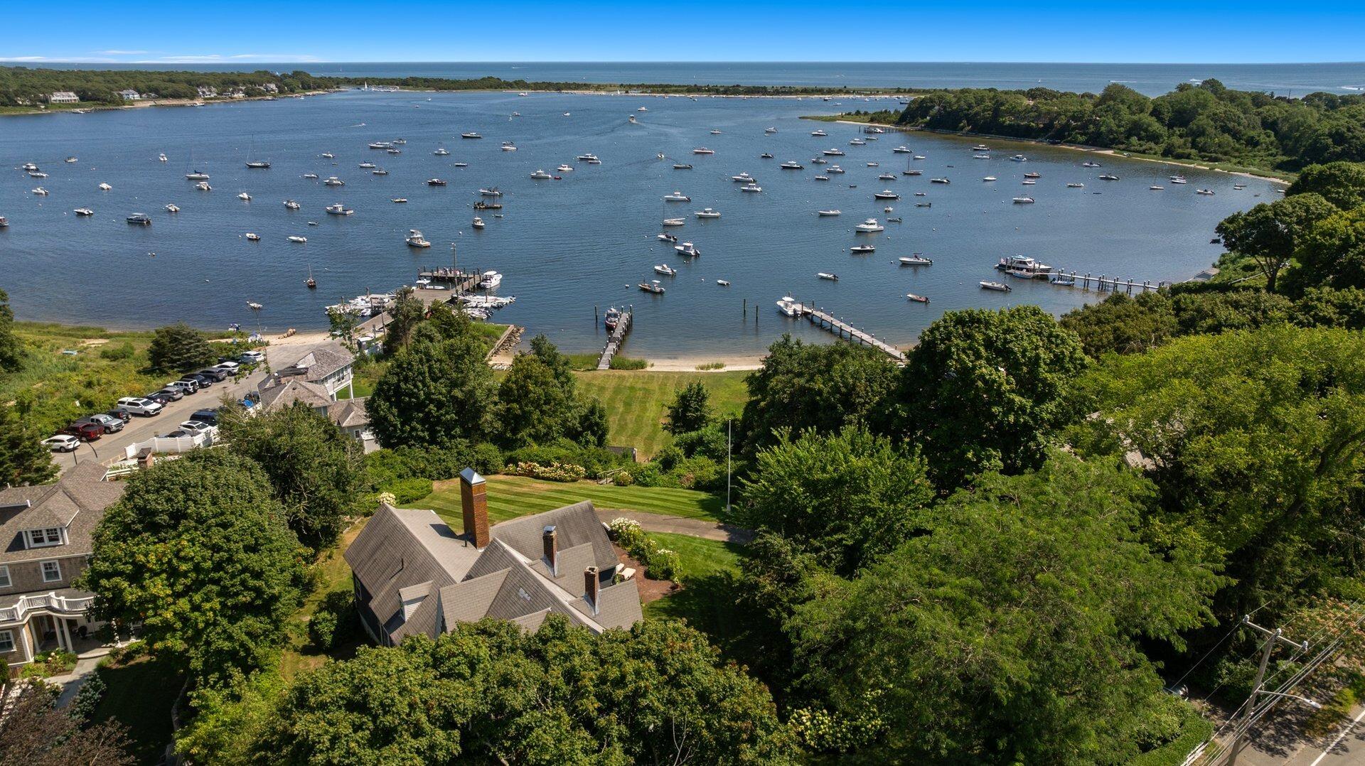 an aerial view of a house with a yard and lake view