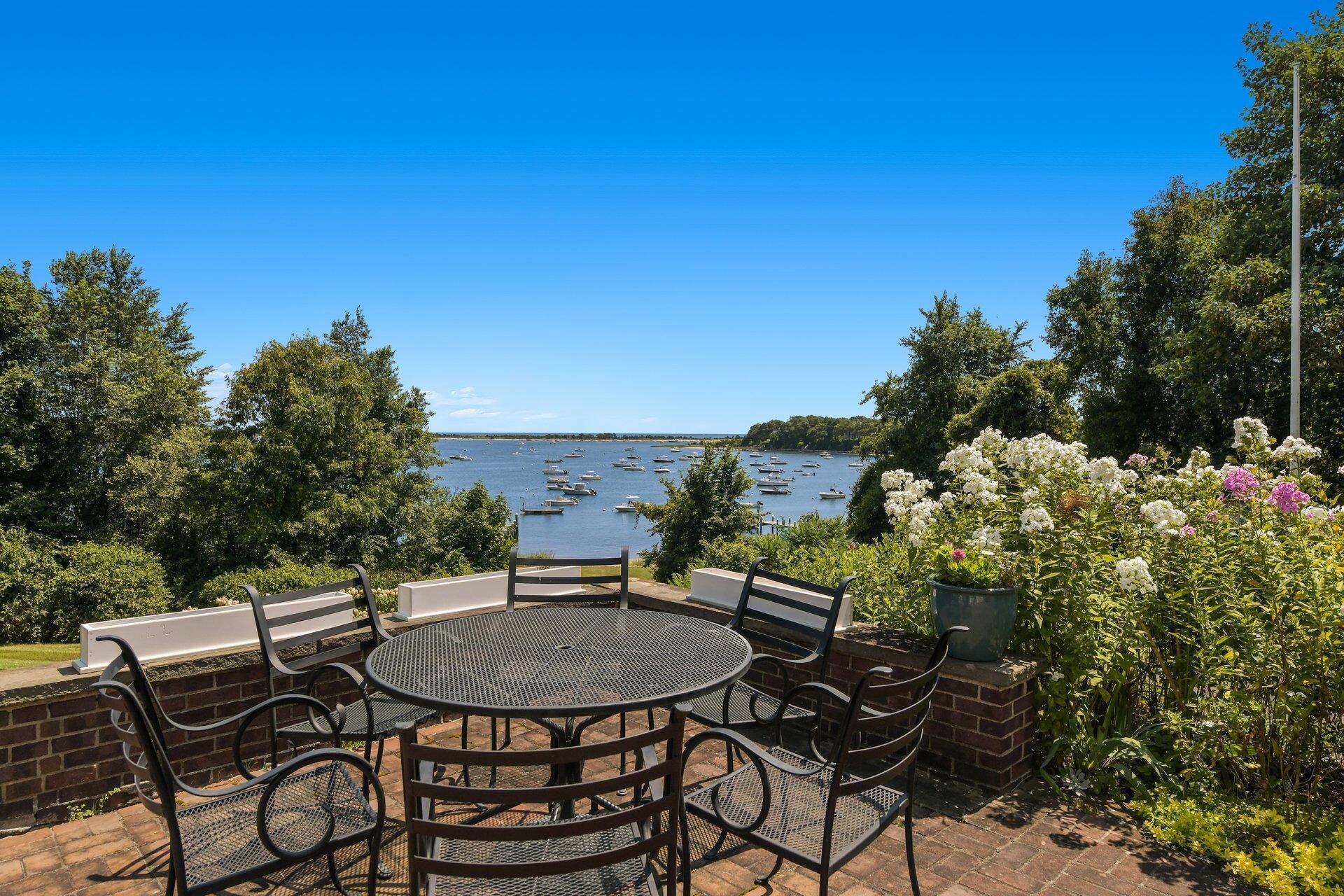 916 Main Street Cotuit, MA 02635 - Photo 19 of 22 a backyard of a house with table and chairs