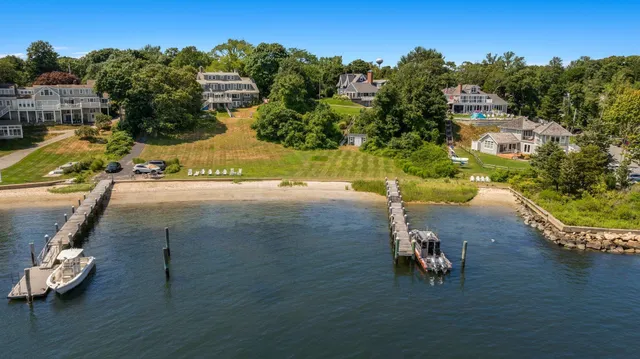 an aerial view of a house with a yard basket ball court and outdoor seating