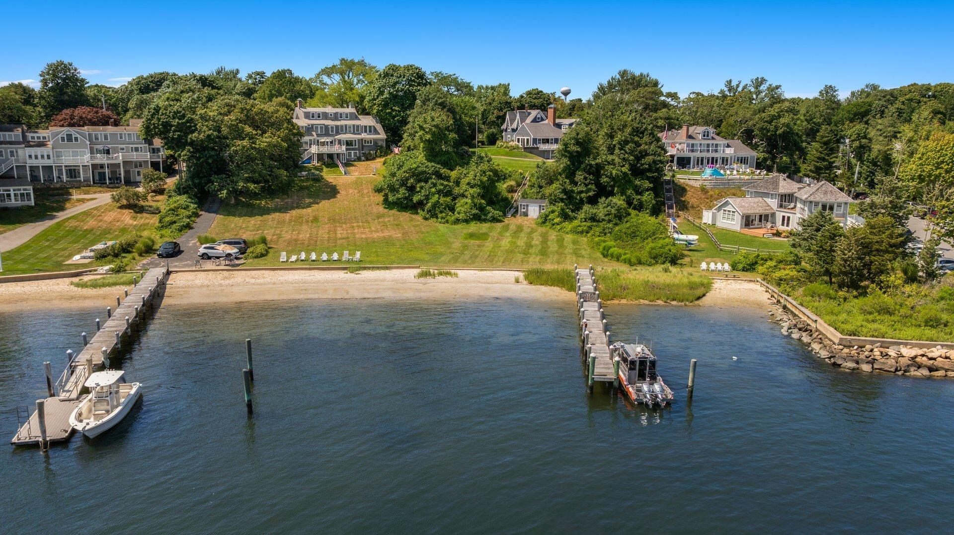 916 Main Street Cotuit, MA 02635 - Photo 2 of 22 an aerial view of a house with a yard basket ball court and outdoor seating