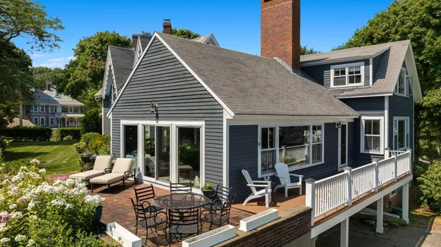 a view of a house with backyard porch and sitting area