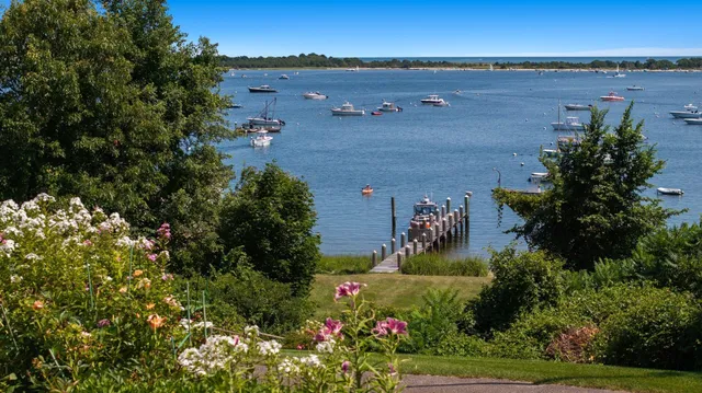an aerial view of a house with a yard and lake view