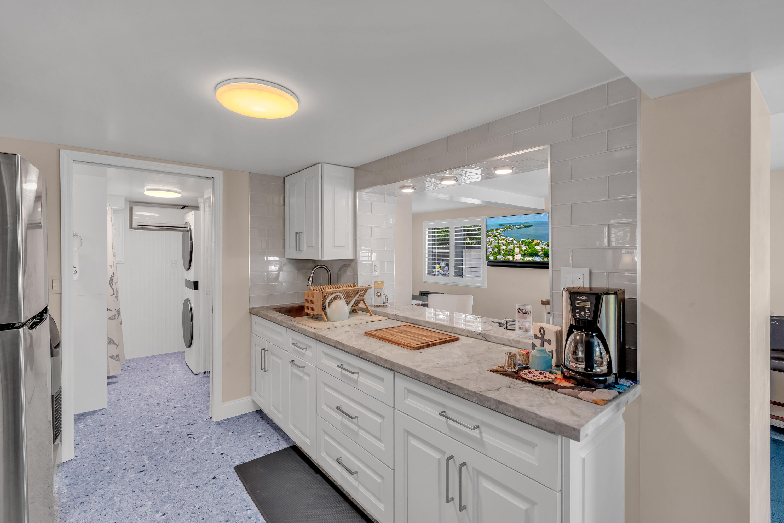 129 Pirates Drive Key Largo, FL 33037 - Photo 18 of 42 a bathroom with a granite countertop sink and a mirror