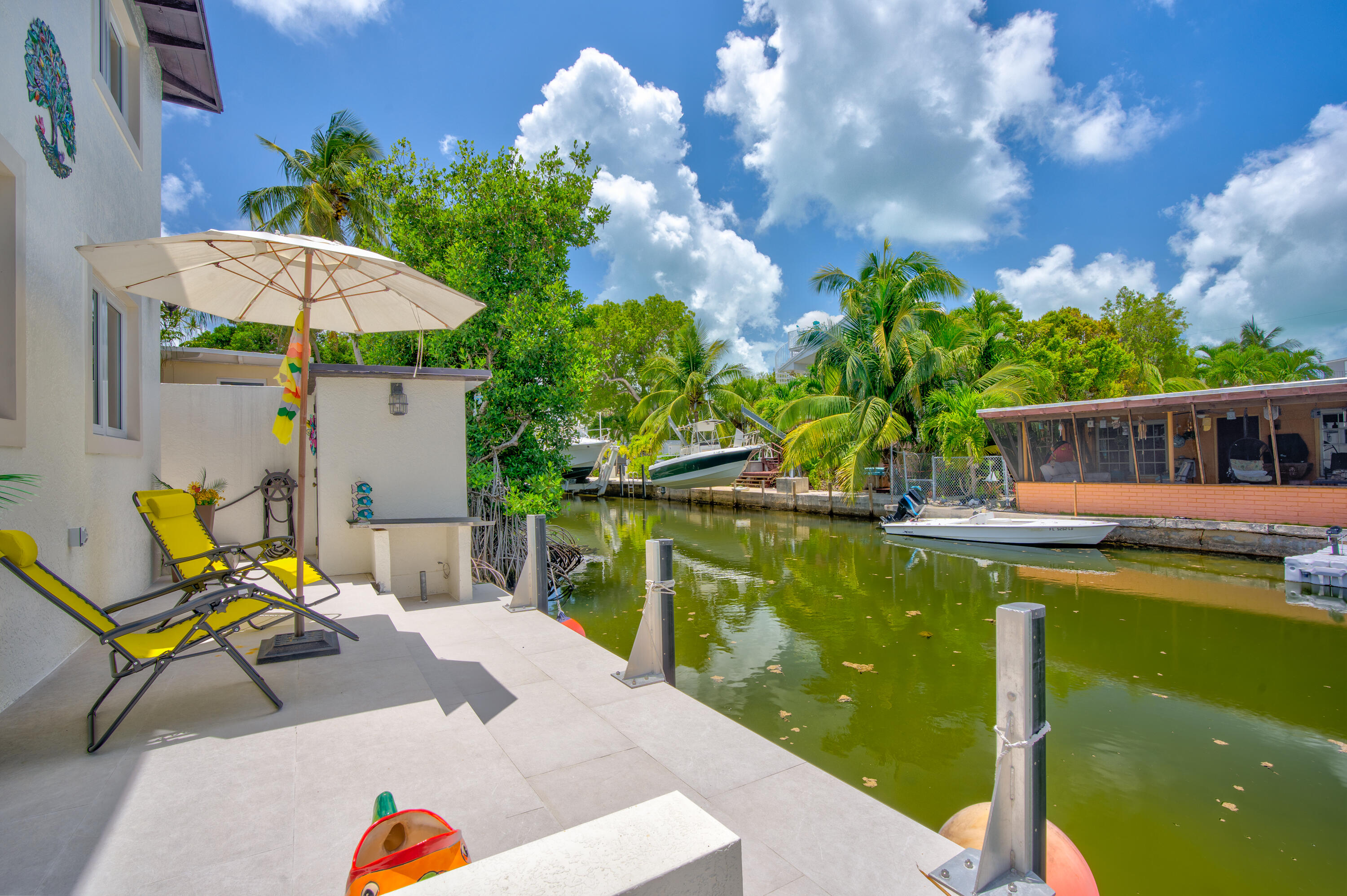 129 Pirates Drive Key Largo, FL 33037 - Photo 27 of 42 a view of a swimming pool with a lounge chairs