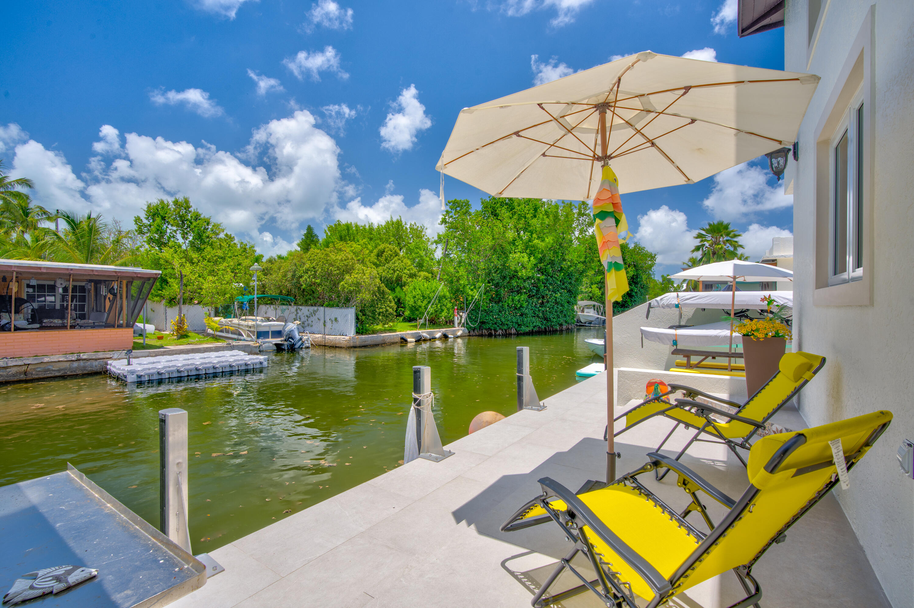 129 Pirates Drive Key Largo, FL 33037 - Photo 30 of 42 a view of a swimming pool with a lounge chairs