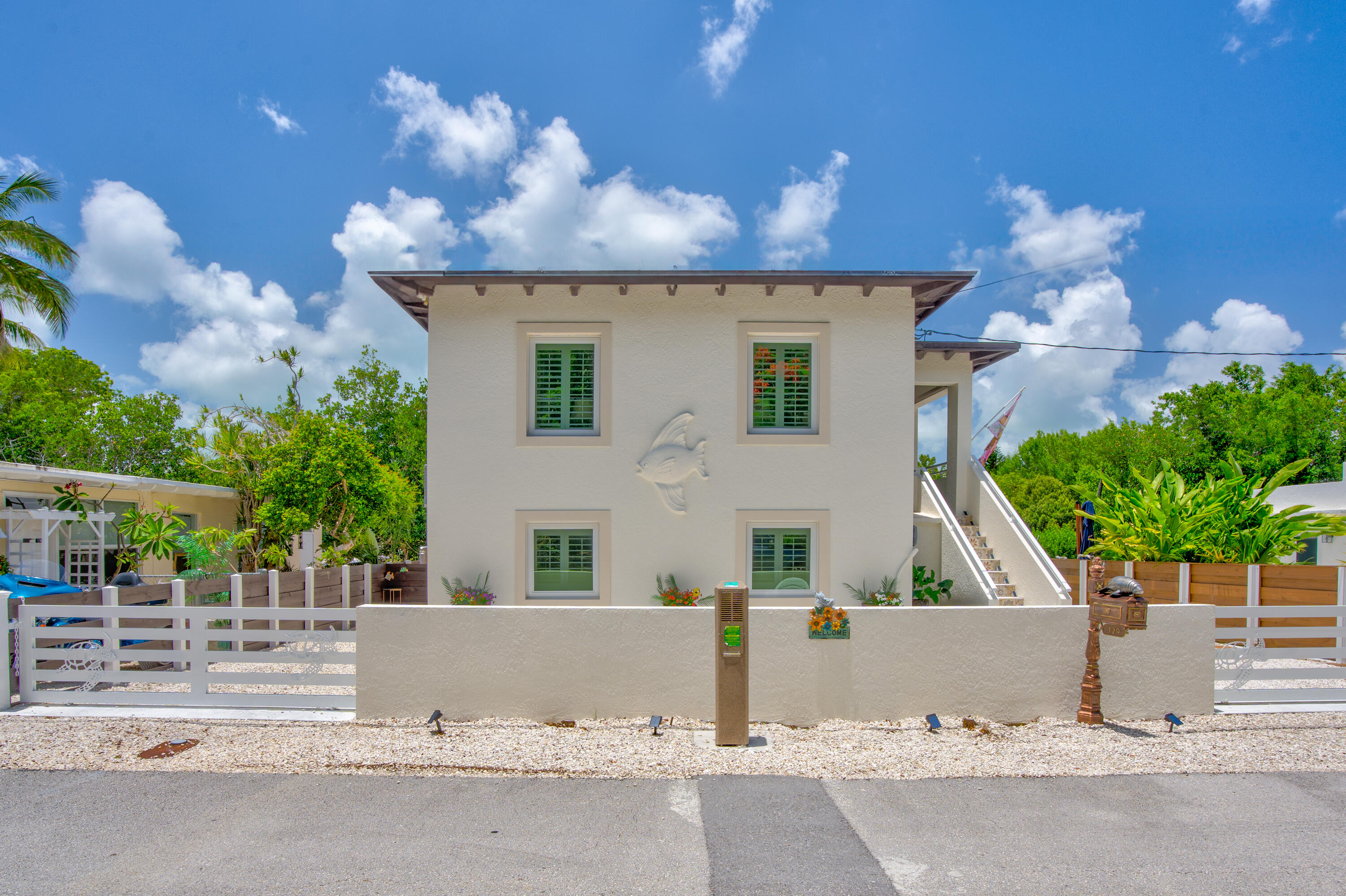 129 Pirates Drive Key Largo, FL 33037 - Photo 31 of 42 front view of house with a yard and potted plants