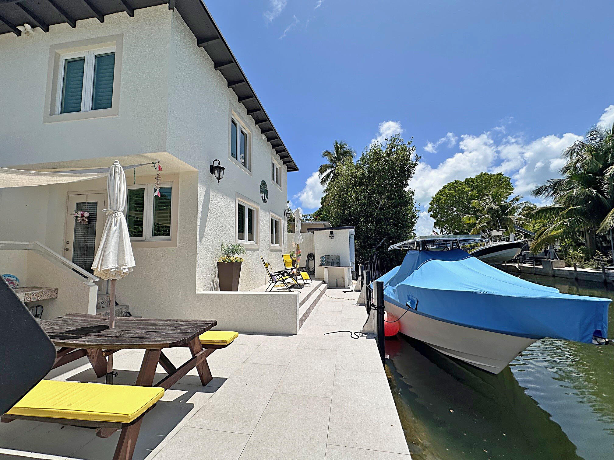 129 Pirates Drive Key Largo, FL 33037 - Photo 32 of 42 a backyard of a house with outdoor seating