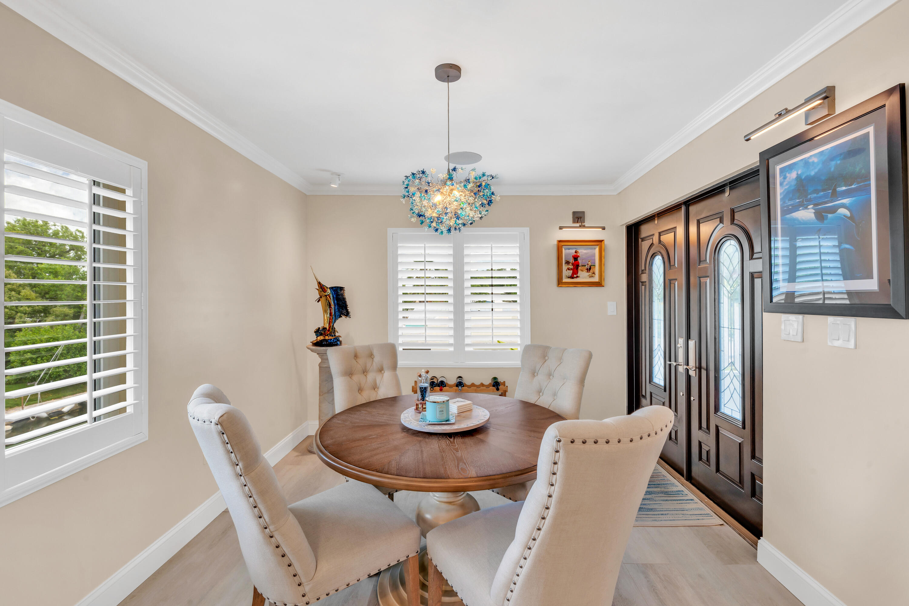 129 Pirates Drive Key Largo, FL 33037 - Photo 5 of 42 a view of a dining room with furniture wooden floor and a chandelier