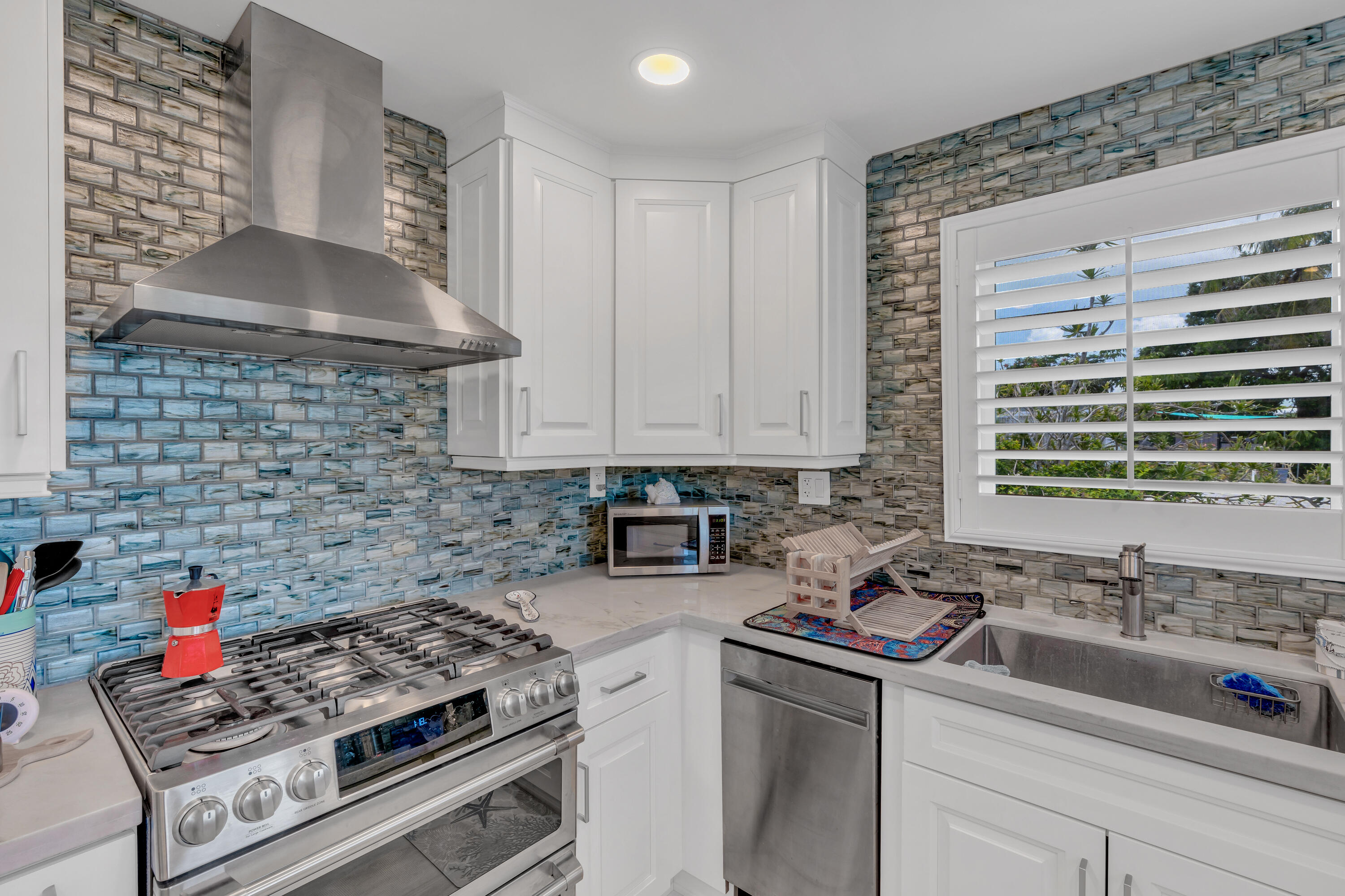 129 Pirates Drive Key Largo, FL 33037 - Photo 8 of 42 a kitchen with stainless steel appliances a sink stove and cabinets