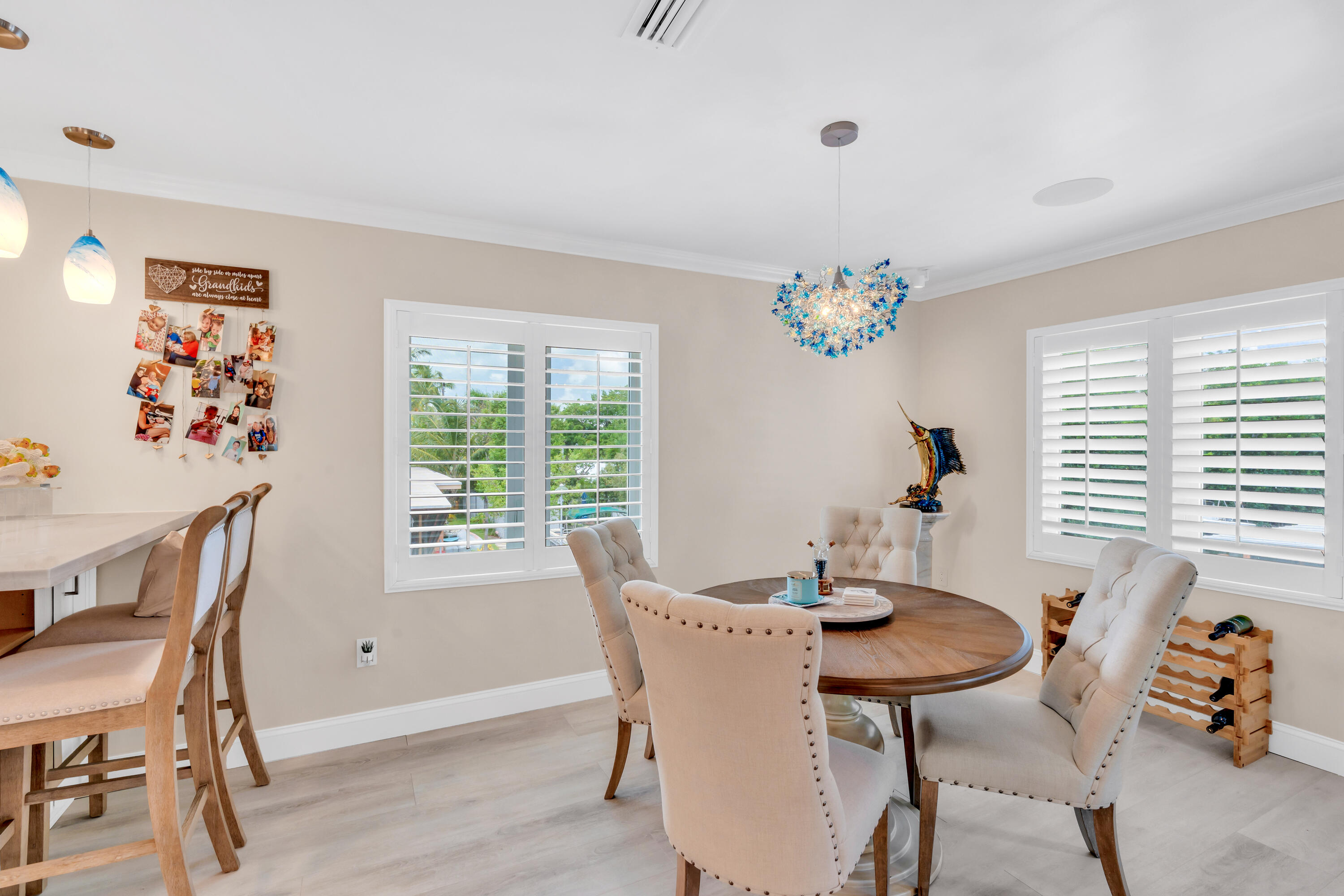 129 Pirates Drive Key Largo, FL 33037 - Photo 10 of 42 a dining room with furniture a window and a chandelier