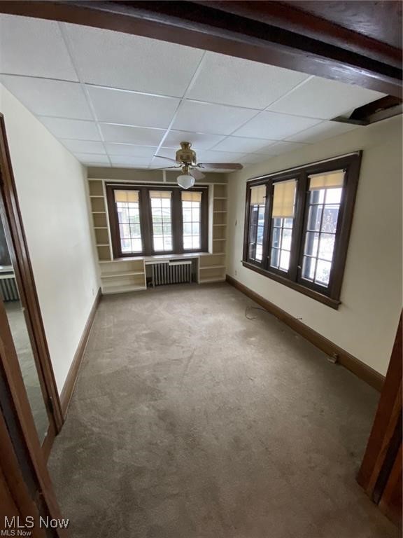 642 East Wilbeth Road Akron, OH 44306 - Photo 12 of 39 Unit 1 bedroom featuring radiator heating unit, ceiling fan, a paneled ceiling, and light carpet