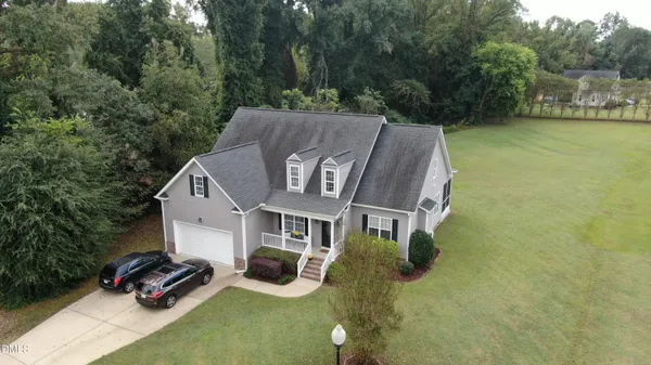 a aerial view of a house with swimming pool and garden