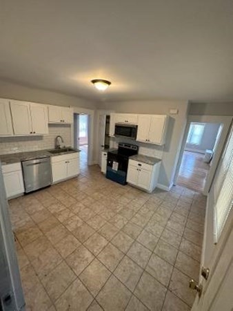 37-39 Fountain Street Springfield, MA 01108 - Photo 5 of 13 a large white kitchen with a stove top oven a sink and dishwasher
