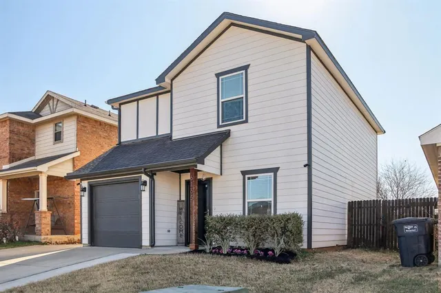 a view of a house with a yard and garage