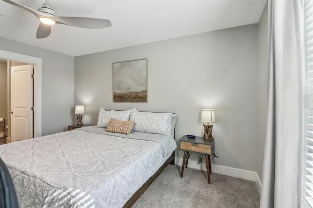 a bedroom with a bed and a night stand