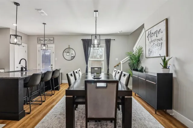 a view of a dining room with furniture window and wooden floor