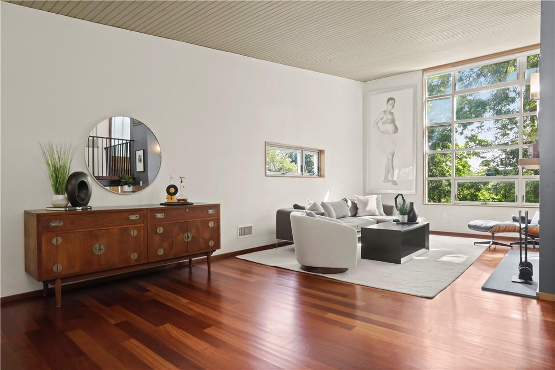 a living room with furniture window and wooden floor