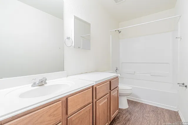a bathroom with a sink a vanity and a shower