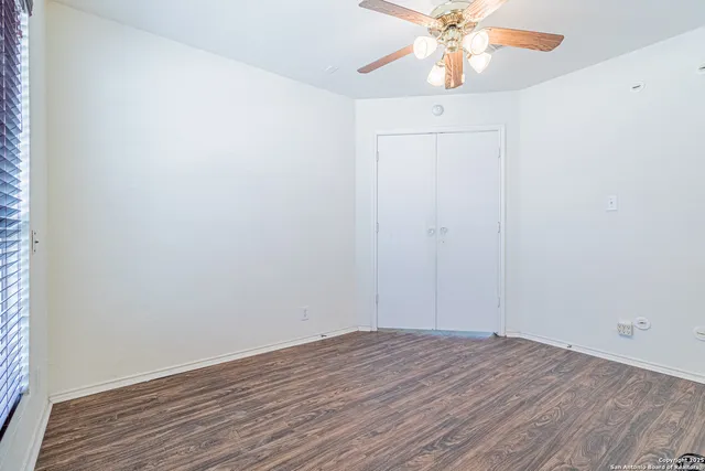 a view of a room with wooden floor and a window