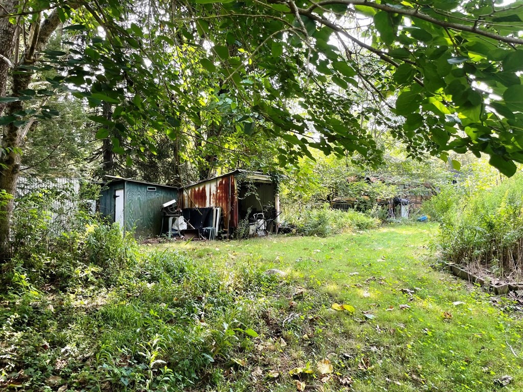 22 Maple Street Norton, MA 02766 - Photo 29 of 32 a backyard of a house with table and chairs