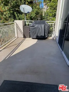 a view of balcony with wooden floor