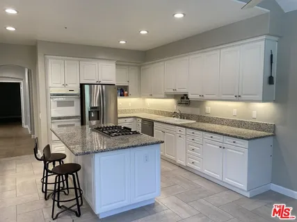 a kitchen with stainless steel appliances granite countertop a sink counter space and cabinets