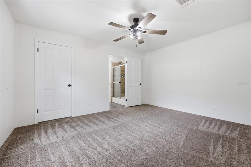 215 Southwest Alpine Place High Springs, FL 32643 - Photo 29 of 41 a view of an empty room with chandelier fan