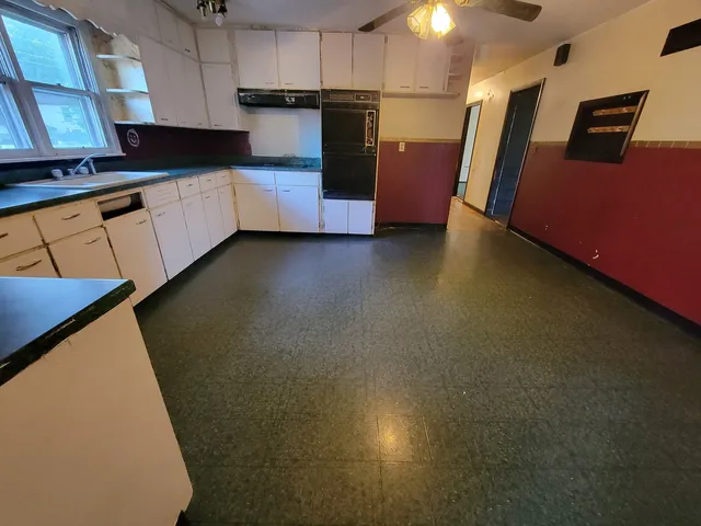 a view of a room with wooden floor and stairs