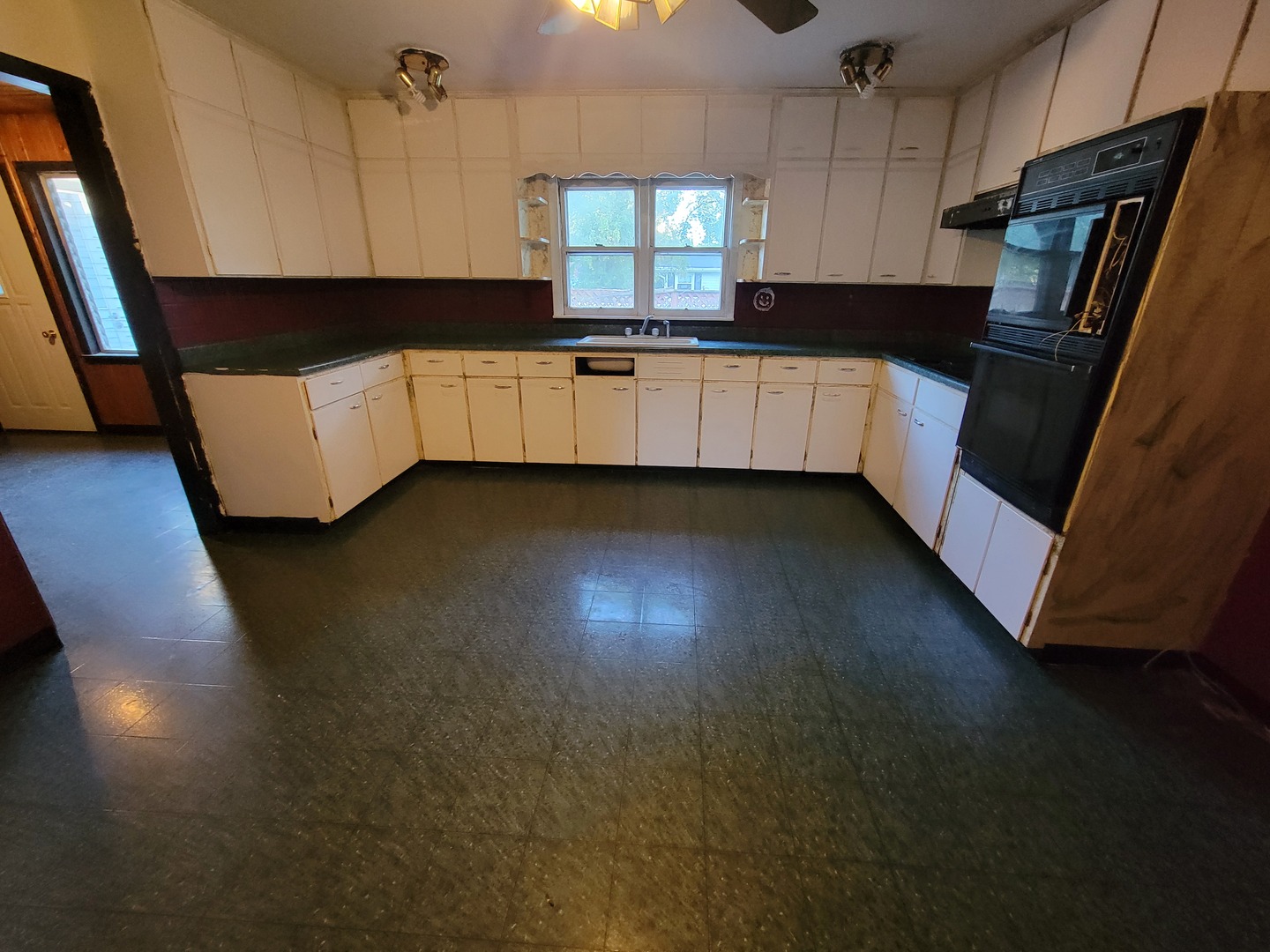 204 Williams Street Henry, IL 61537 - Photo 2 of 35 a kitchen with granite countertop stainless steel appliances a sink a refrigerator a stove a microwave and a window