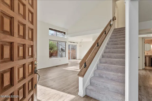 a view of a hallway with windows and stairs