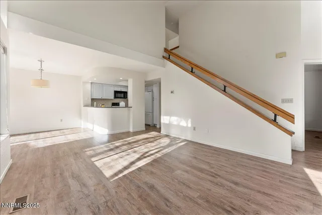a view of a kitchen with stainless steel appliances granite countertop a sink and cabinets