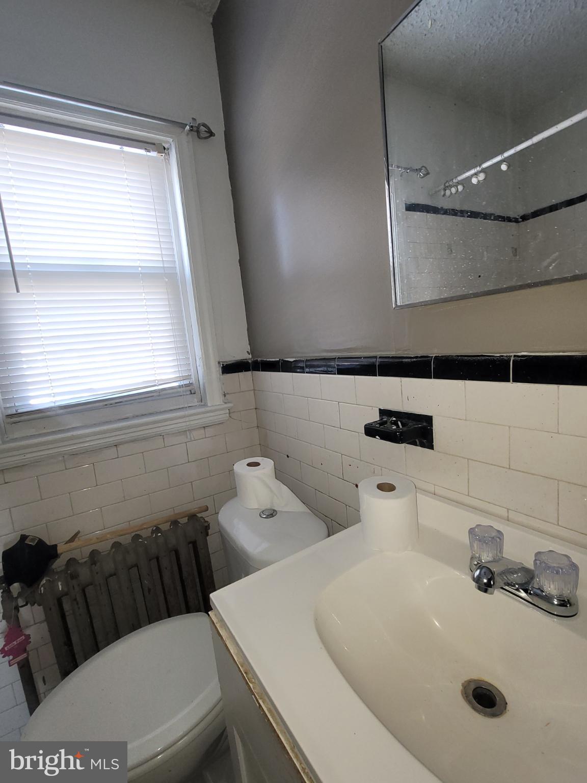 2523 Boarman Avenue Baltimore, MD 21215 - Photo 14 of 31 a bathroom with a sink a toilet and a mirror