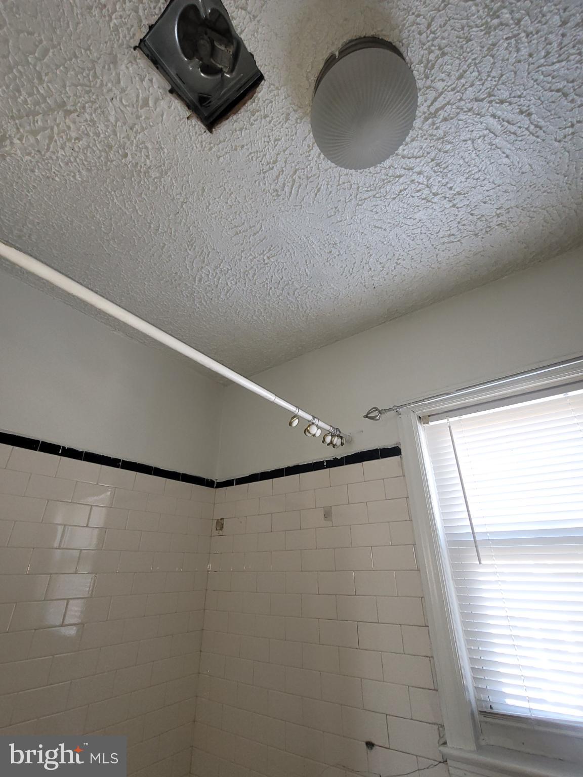 2523 Boarman Avenue Baltimore, MD 21215 - Photo 15 of 31 a bathroom with a shower curtain and a window