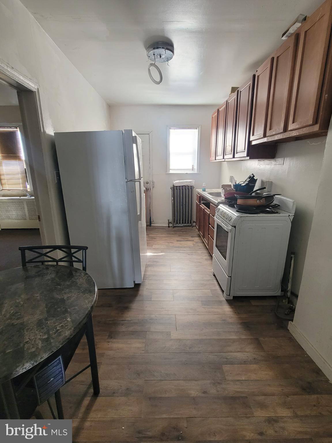2523 Boarman Avenue Baltimore, MD 21215 - Photo 9 of 31 a kitchen with granite countertop a stove a refrigerator and wooden floor