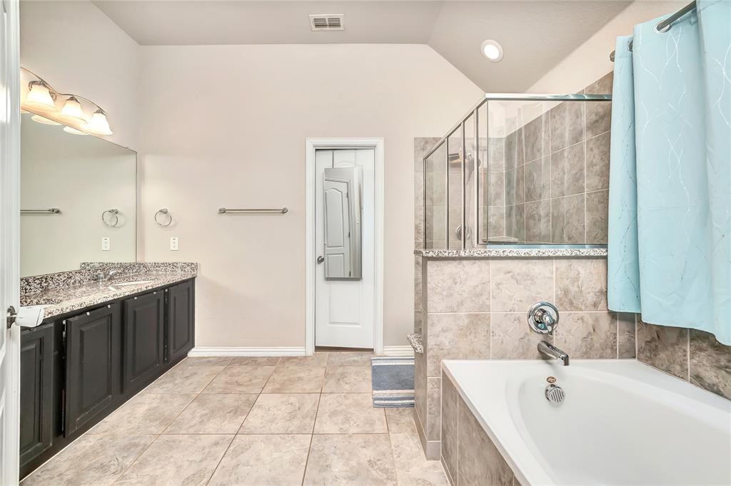 1008 Hoxton Road Forney, TX 75126 - Photo 7 of 39 a bathroom with a tub sink and mirror