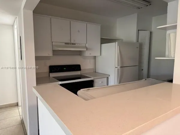 a kitchen with a stove and a microwave