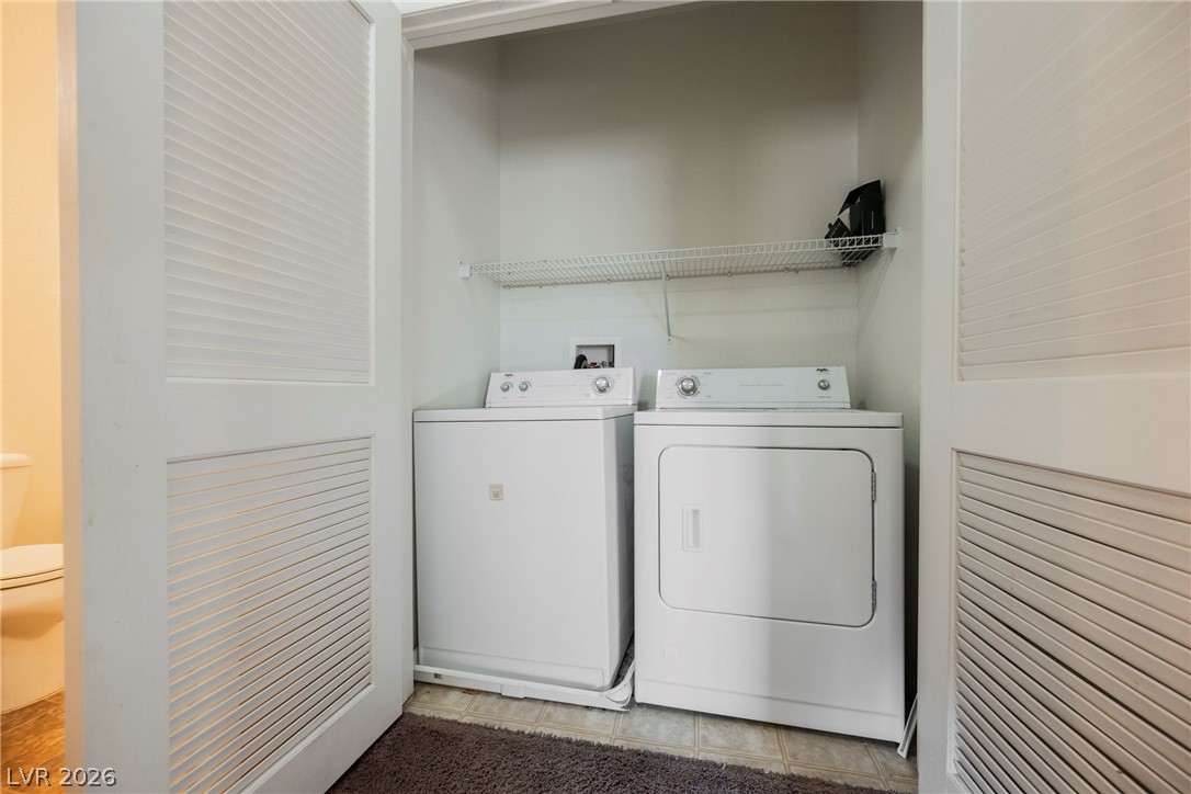 6320 Snap Ridge Street, Unit 201 North Las Vegas, NV 89081 - Photo 15 of 56 A dedicated laundry space is conveniently located with a washer and dryer unit.