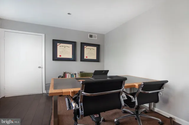 a work room with furniture and wooden floor