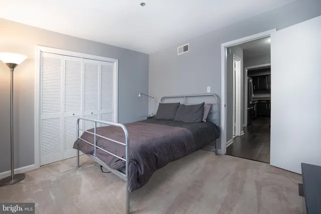 a bedroom with a bed and window