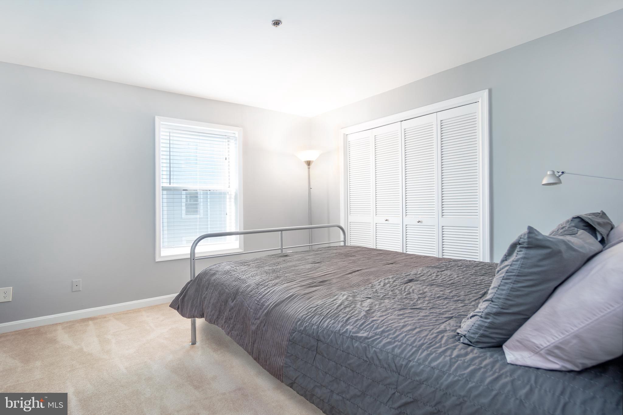 10248 Appalachian Circle, Unit 1D7 Oakton, VA 22124 - Photo 19 of 32 a bedroom with a bed and a window