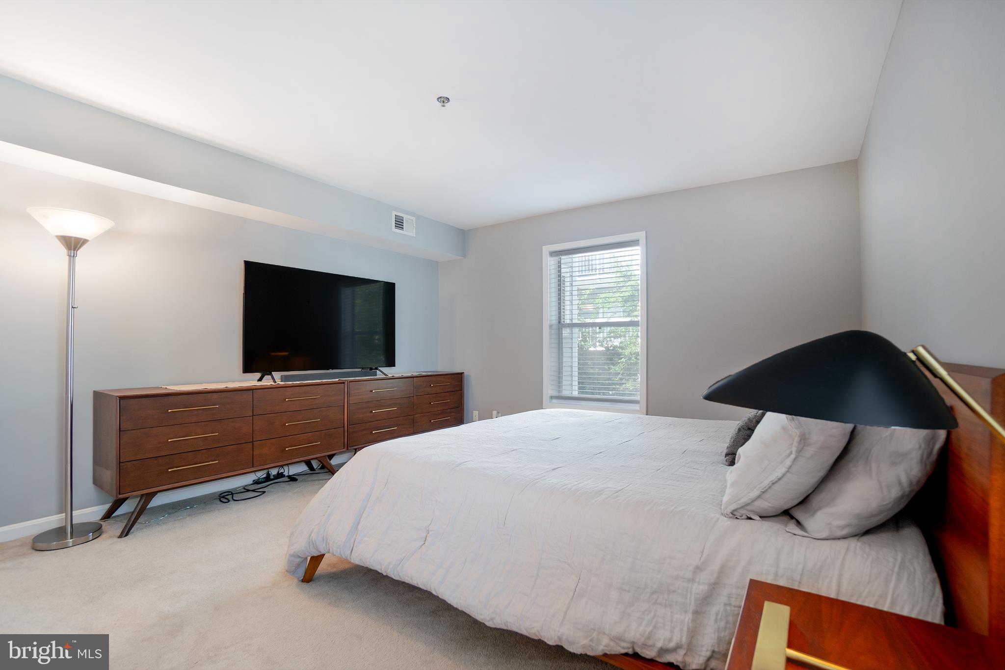 10248 Appalachian Circle, Unit 1D7 Oakton, VA 22124 - Photo 22 of 32 a bedroom with a bed and a flat screen tv