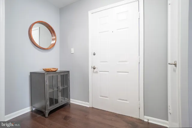 a view of a room with wooden floor and a sink