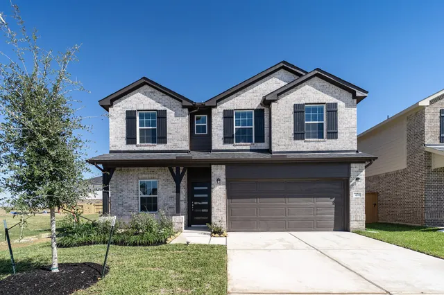 a front view of a house with garage