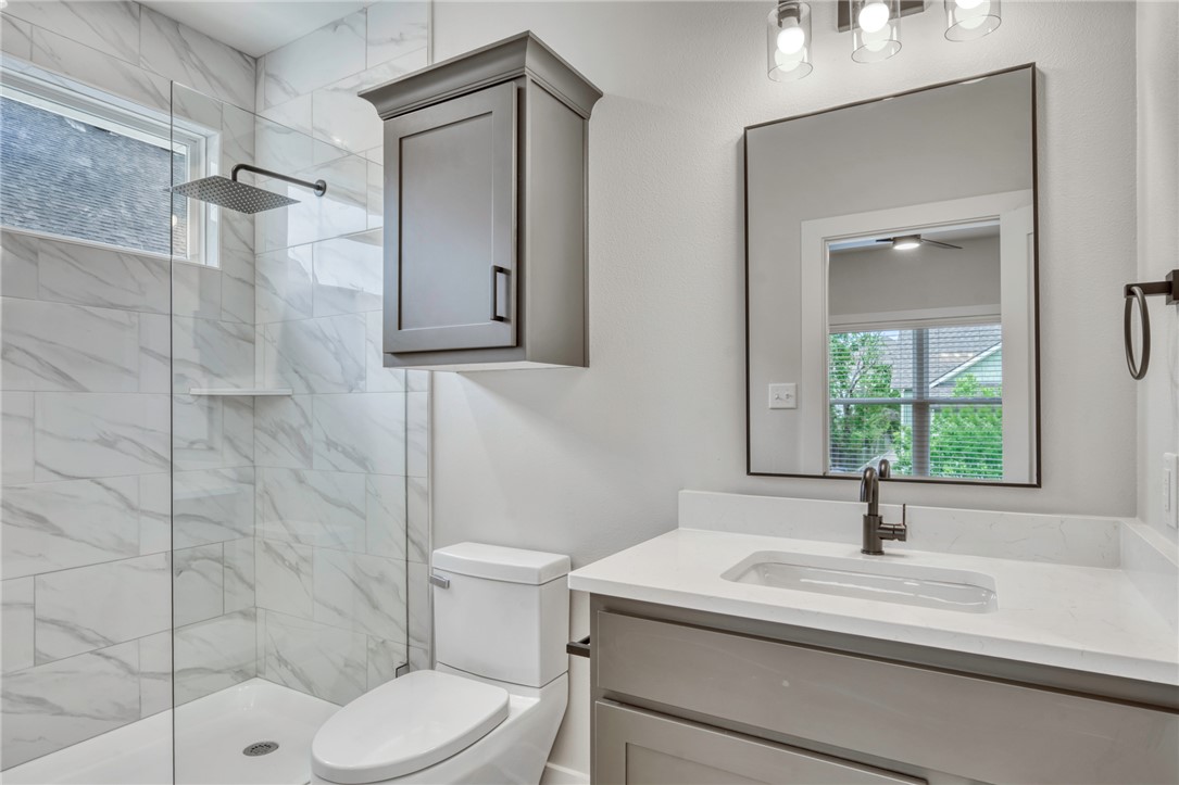 301 Cooner Street, Unit A College Station, TX 77840 - Photo 21 of 36 a bathroom with a sink a toilet and shower