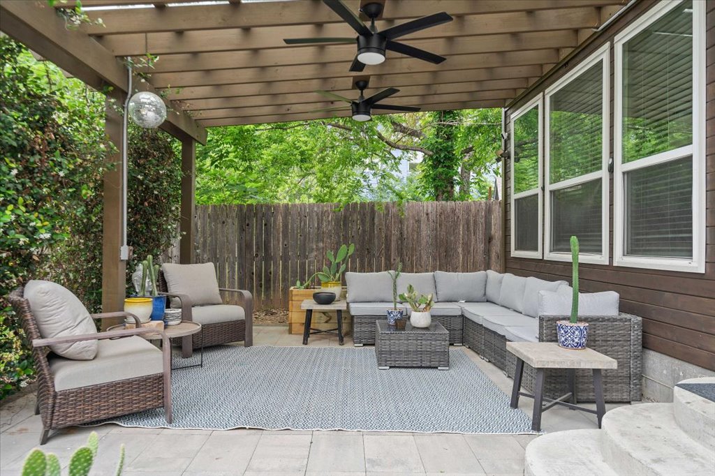 1800 Webberville Road, Unit B Austin, TX 78721 - Photo 27 of 30 Covered patio featuring a wood slatted pergola, two ceiling fans, and a tiled floor