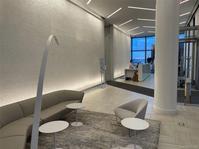 a room with lots of furniture and a potted plant