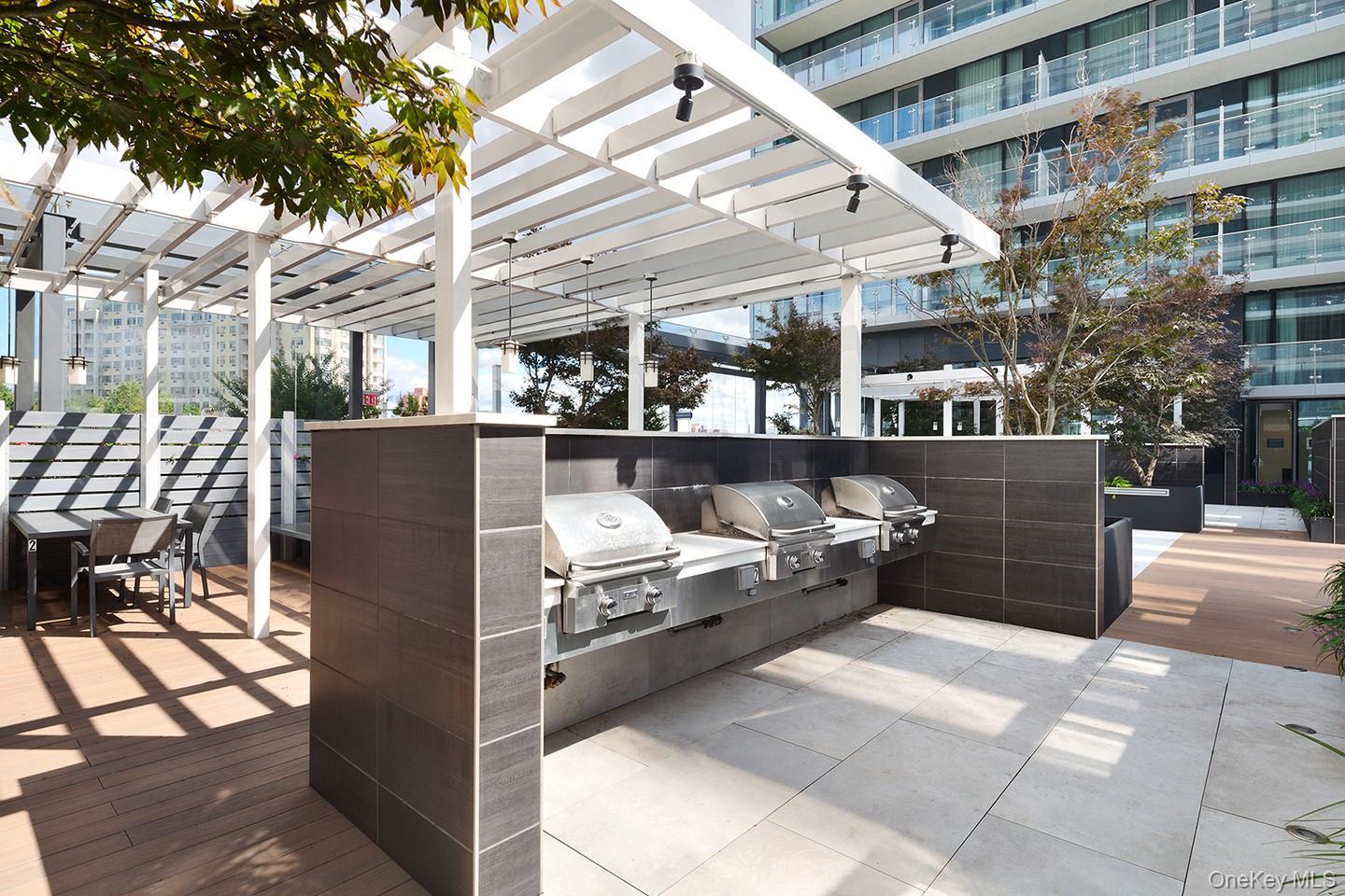 131-05 40 Road, Unit PH1D Queens, NY 11354 - Photo 22 of 23 View of patio / terrace with exterior kitchen and outdoor dining area