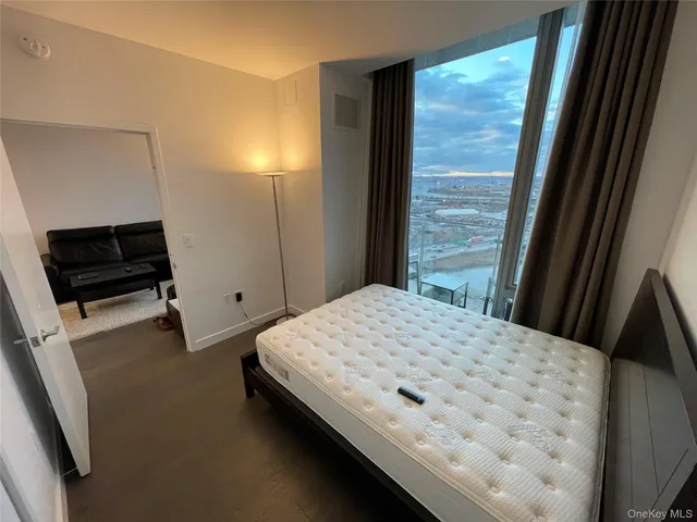 a bed sitting in a bedroom next to a window