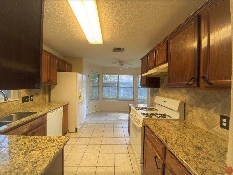 1903 Balsam Way Round Rock, TX 78665 - Photo 3 of 21 A well-equipped kitchen features ample counter space and a bay window overlooking the yard.