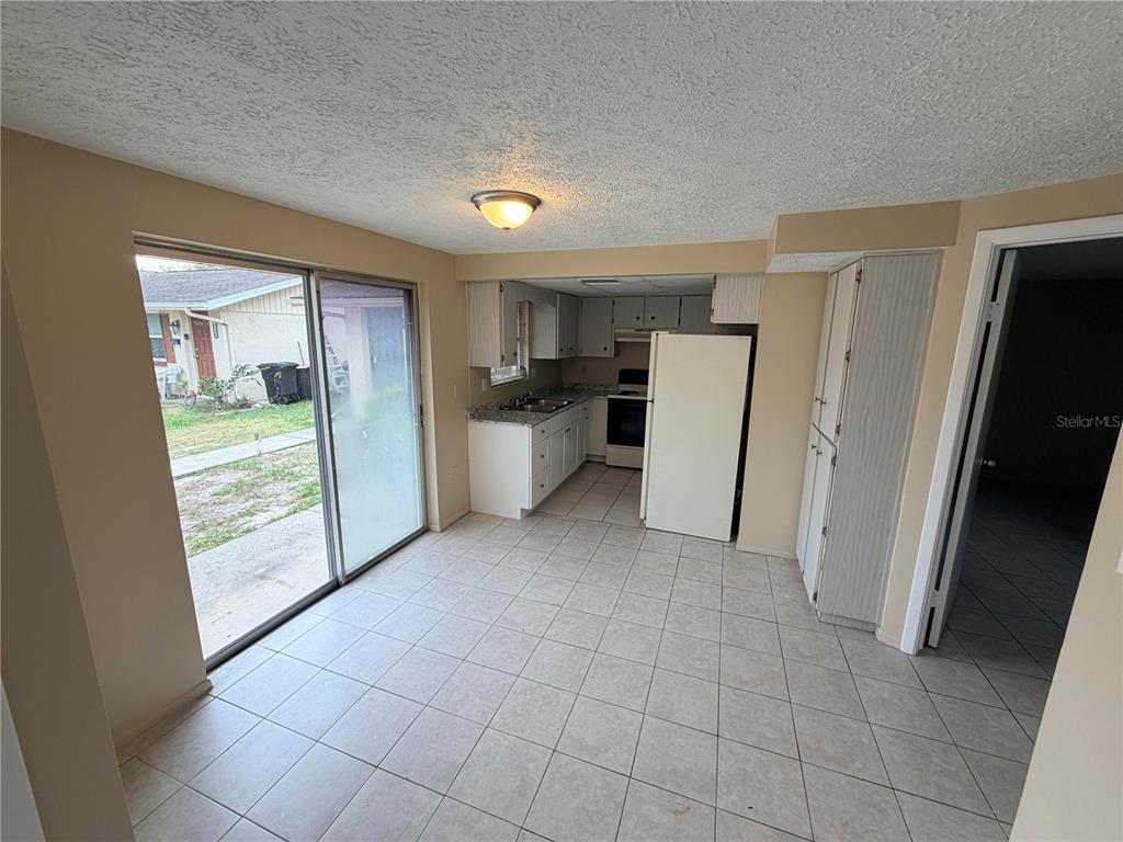 6330 Pennsylvania Avenue New Port Richey, FL 34653 - Photo 6 of 17 a view of a kitchen with refrigerator stove and cabinets